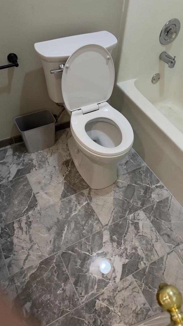 Finished: Bathroom floor tile being leveled and the finished floor