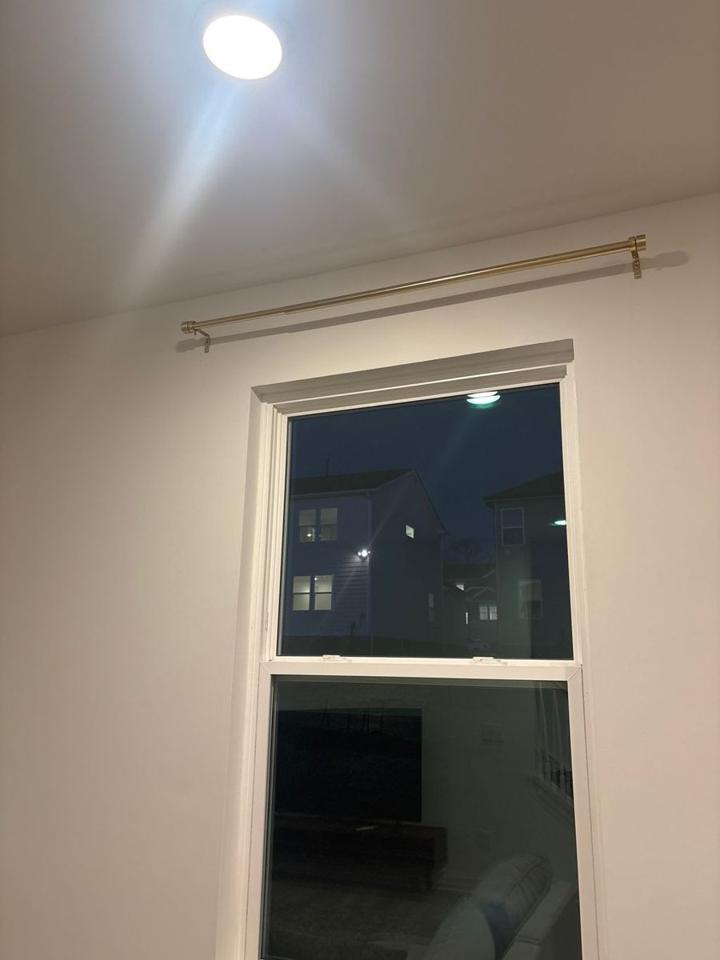 Curtain rod installed above a window