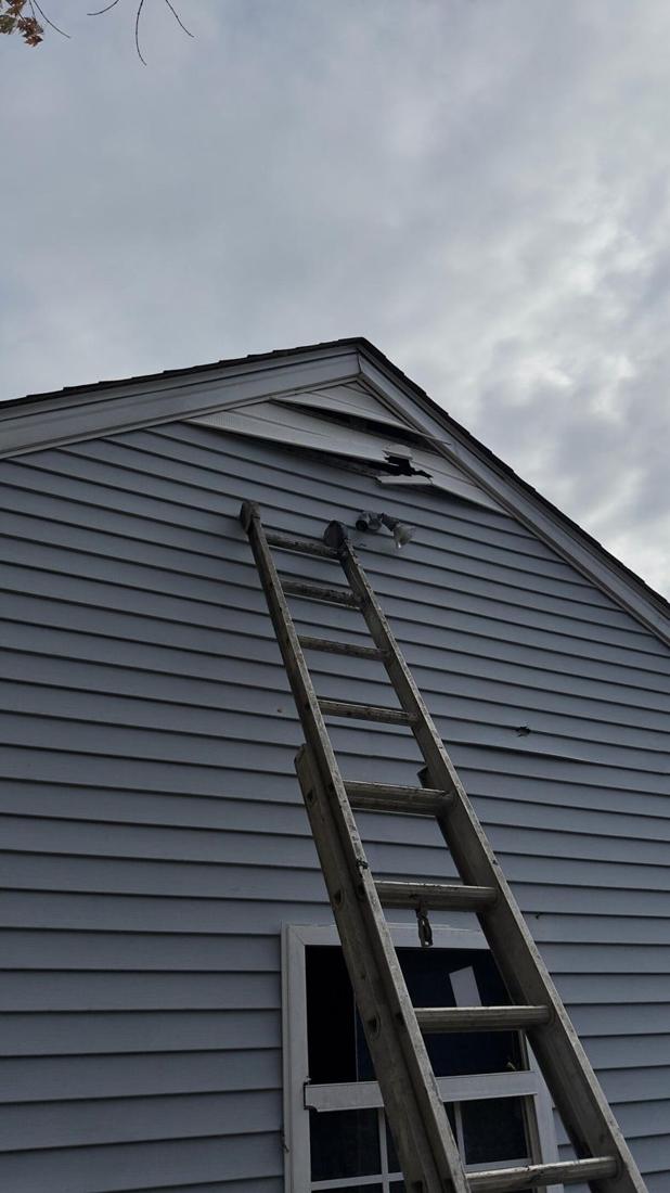 Ladder against a house during a siding repair