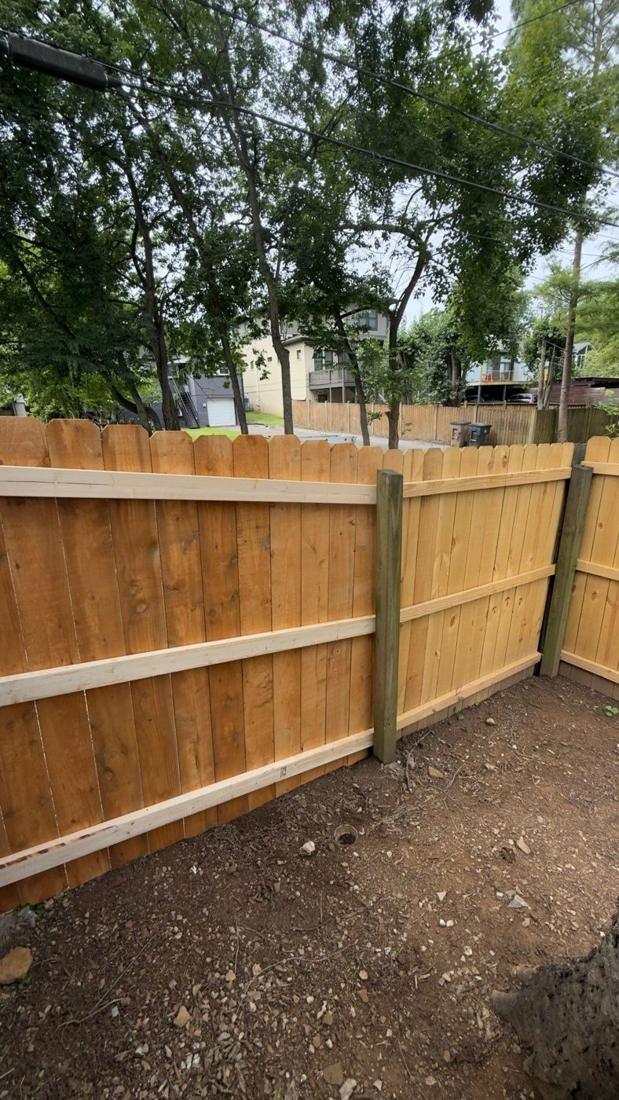New wood privacy fence section in a backyard